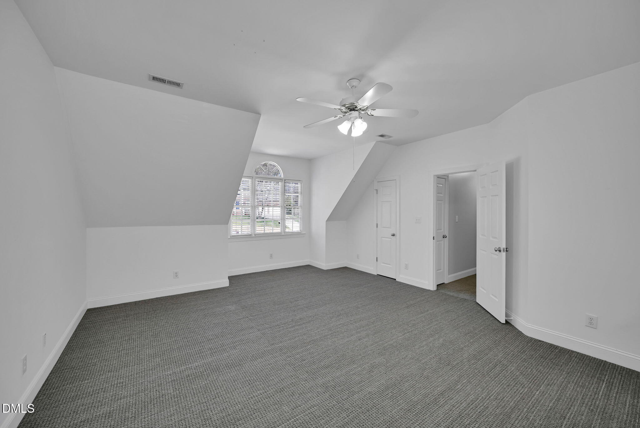 8005 Looking Glass Court Raleigh, NC 27612 - Photo 55 of 75 an empty room with windows and ceiling fan
