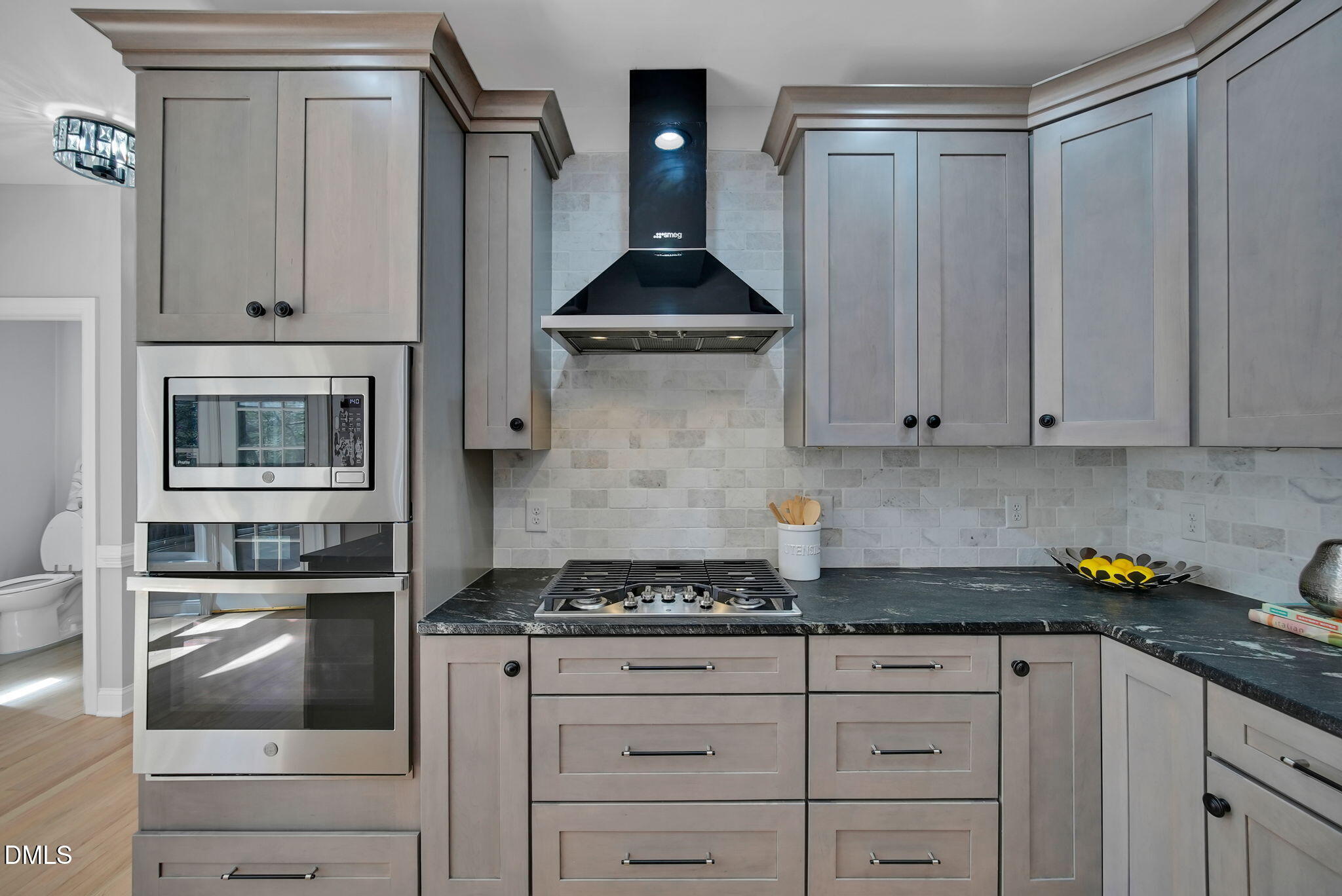 8005 Looking Glass Court Raleigh, NC 27612 - Photo 10 of 75 a kitchen with granite countertop white cabinets and stainless steel appliances