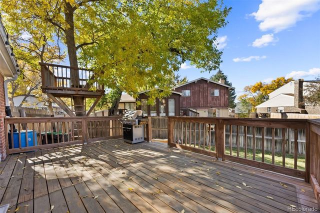 a view of a patio with table and chairs and wooden floor