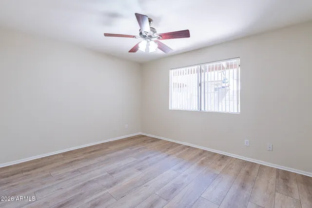 wooden floor in an empty room with a window