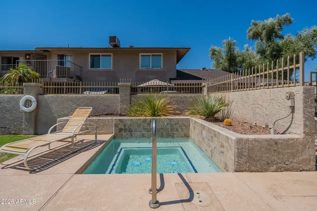 a view of a patio with couches table and chairs with potted plants