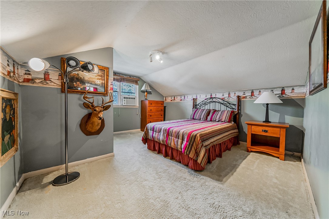 1104 Waverly Road Sandusky, OH 44870 - Photo 26 of 46 Carpeted bedroom with lofted ceiling and a textured ceiling