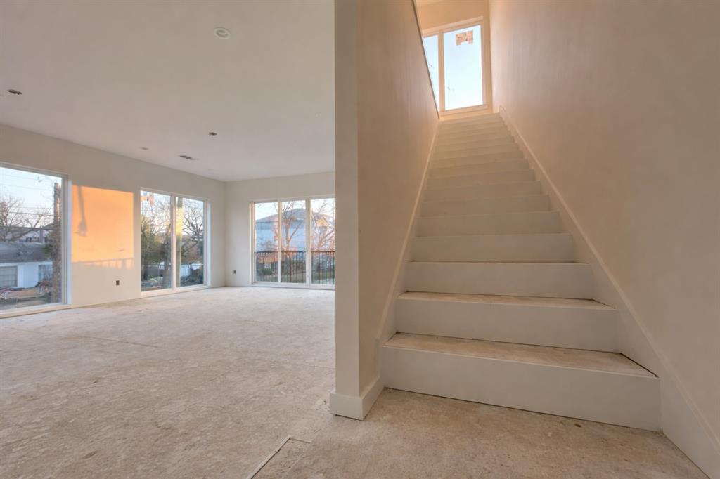 2247 Mail Avenue Dallas, TX 75235 - Photo 16 of 26 a view of an empty room with a fireplace and windows