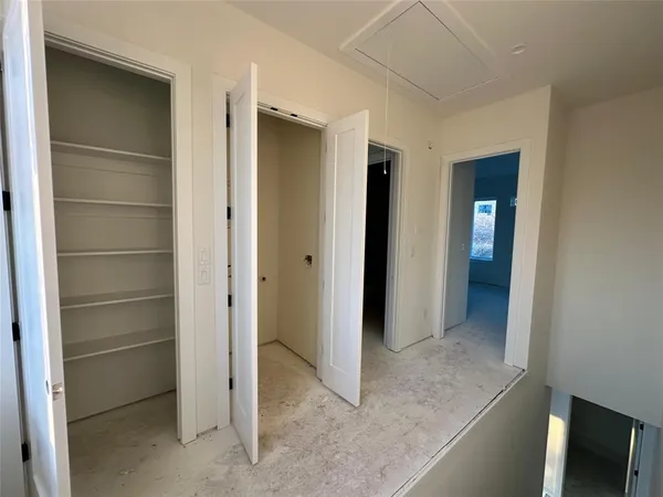 a view of an empty room with window and closet area