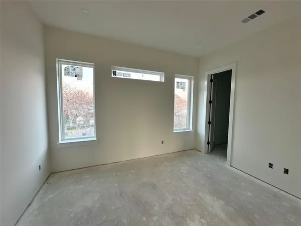 a view of an empty room with windows