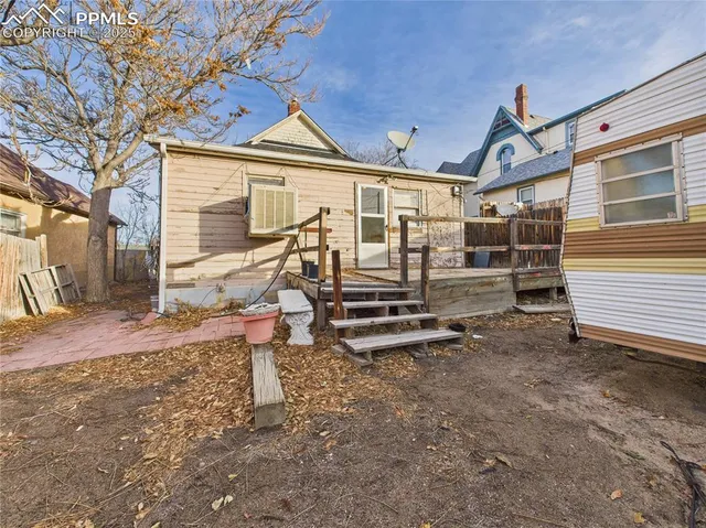 a backyard of a house with barbeque oven table and chairs