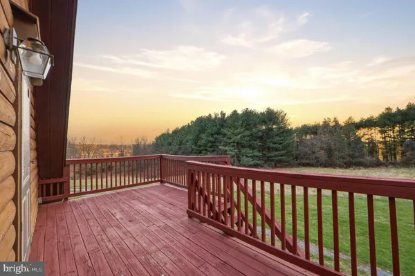 a balcony with wooden floor and fence