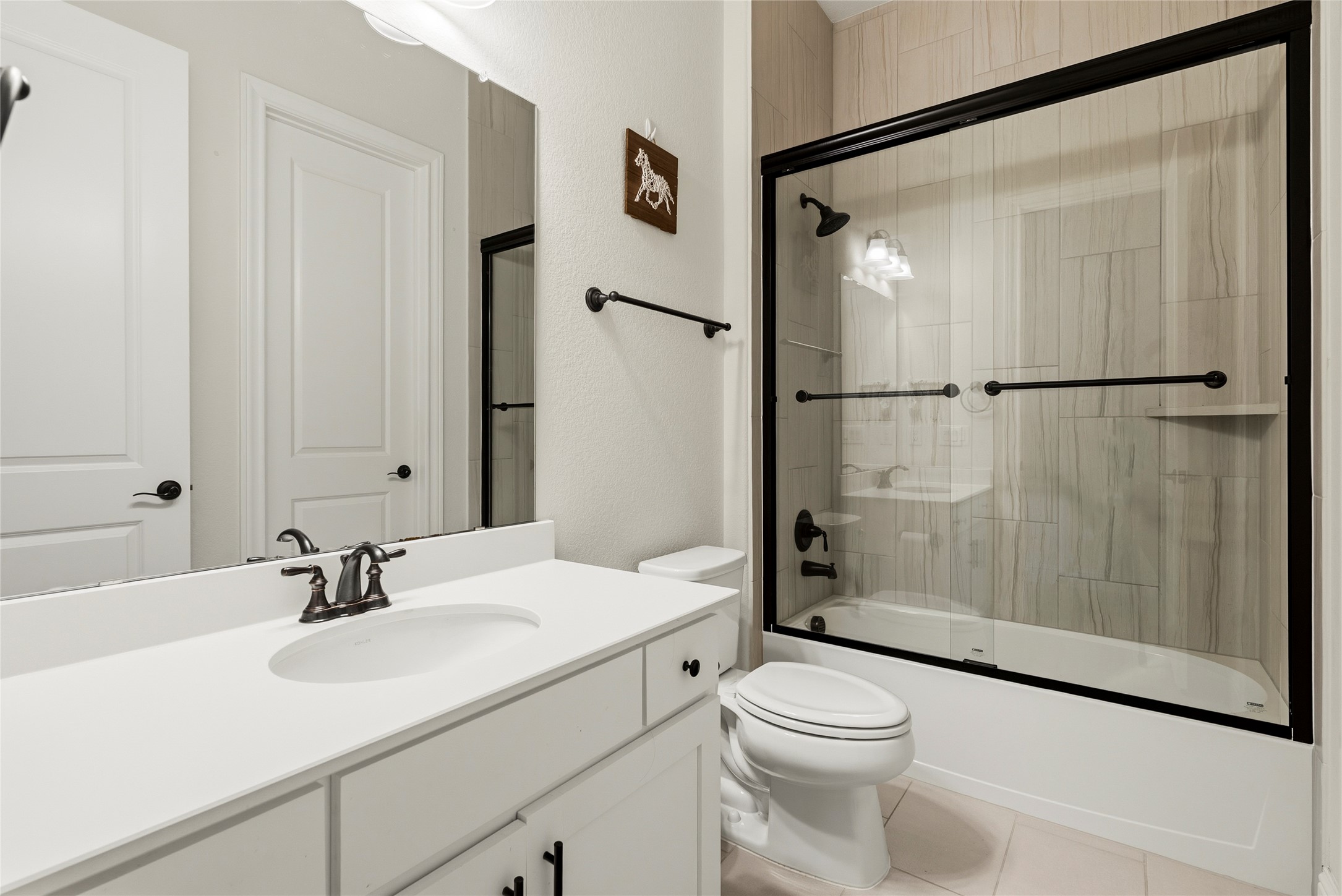 4513 Vieste View Leander, TX 78641 - Photo 36 of 40 Bathroom featuring a single vanity with a white countertop, undermount sink, and dark bronze faucet