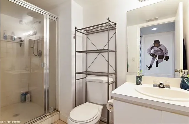 a bathroom with a toilet a sink and a shower