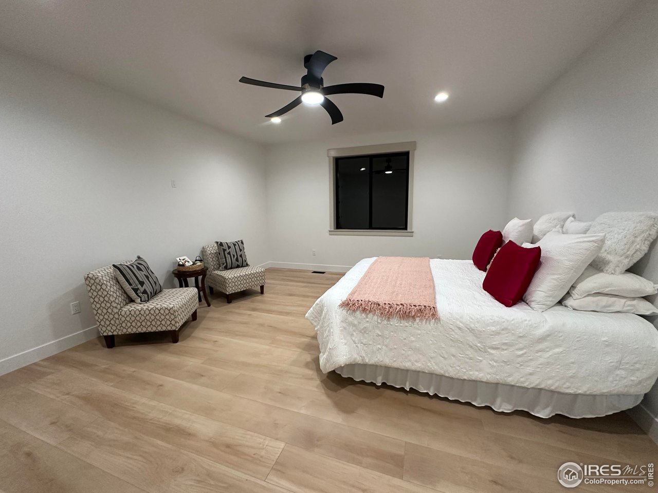 15276 Ypsilon Circle Mead, CO 80542 - Photo 22 of 40 a bedroom with a bed and a ceiling fan