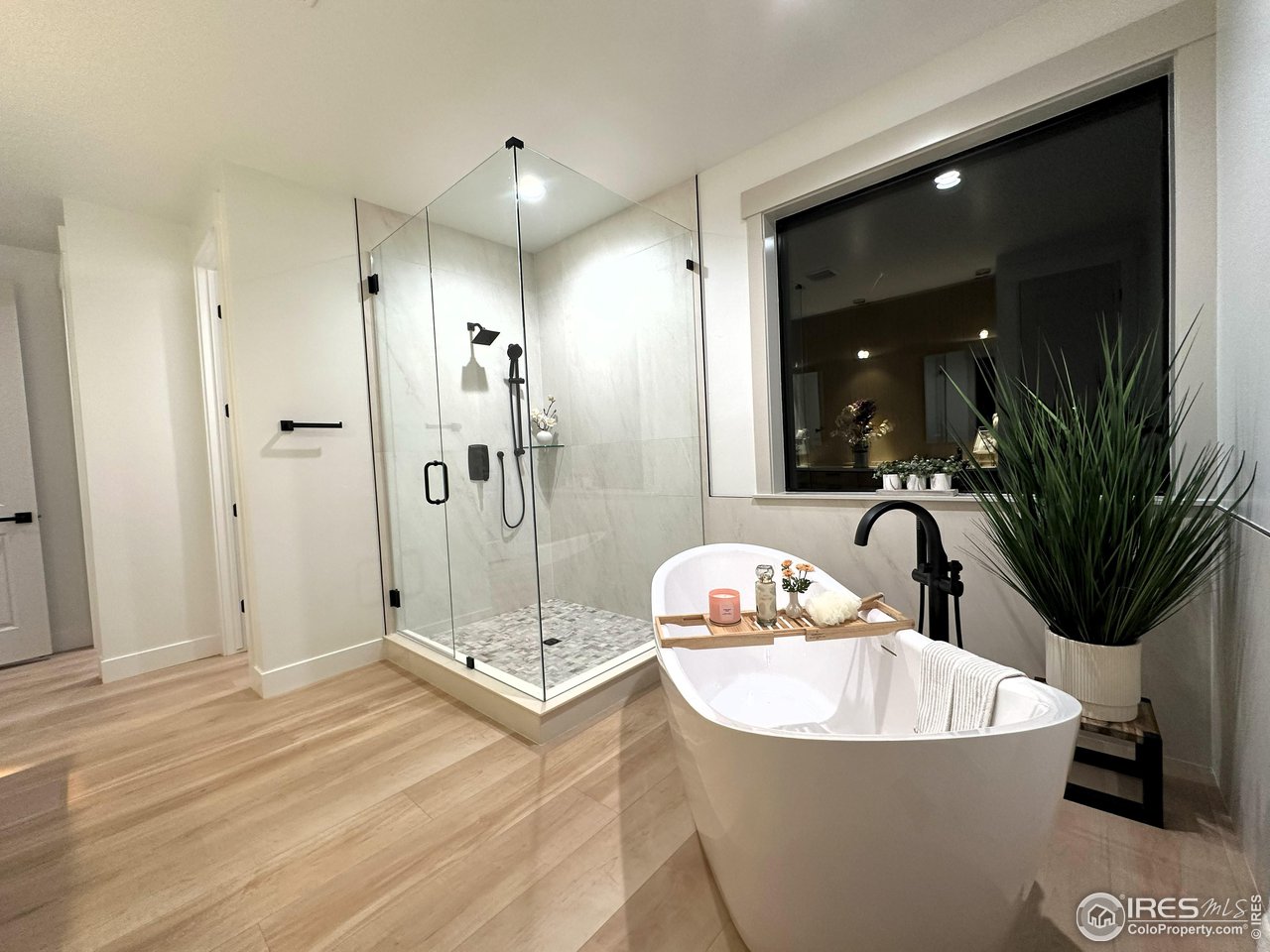 15276 Ypsilon Circle Mead, CO 80542 - Photo 27 of 40 a bathroom with a tub sink and mirror
