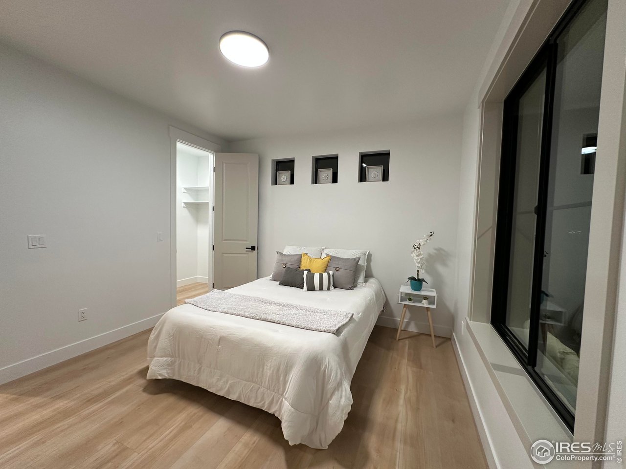 15276 Ypsilon Circle Mead, CO 80542 - Photo 29 of 40 a bedroom with a bed and wooden floor