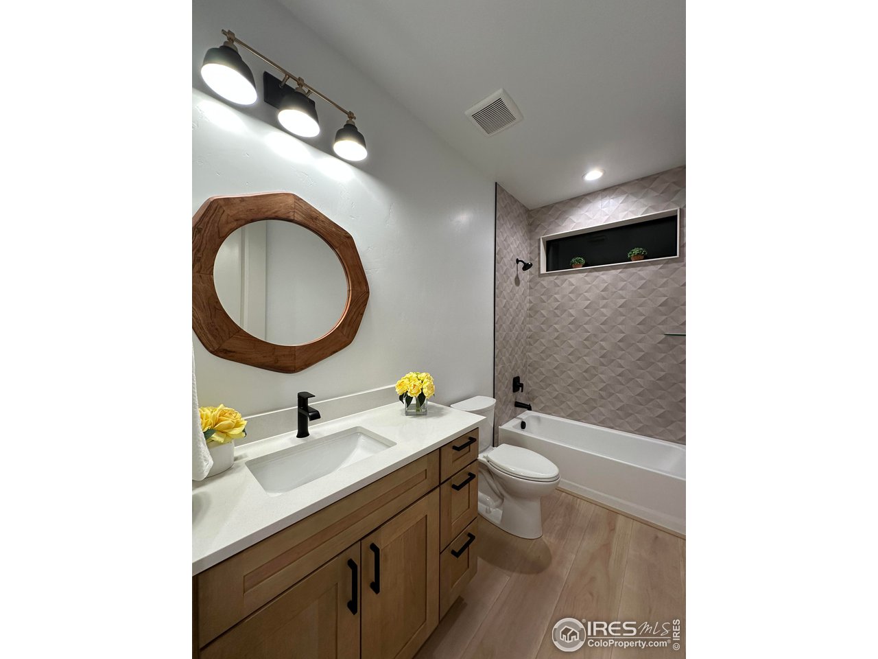 15276 Ypsilon Circle Mead, CO 80542 - Photo 30 of 40 a bathroom with a double vanity sink toilet mirror and bathtub