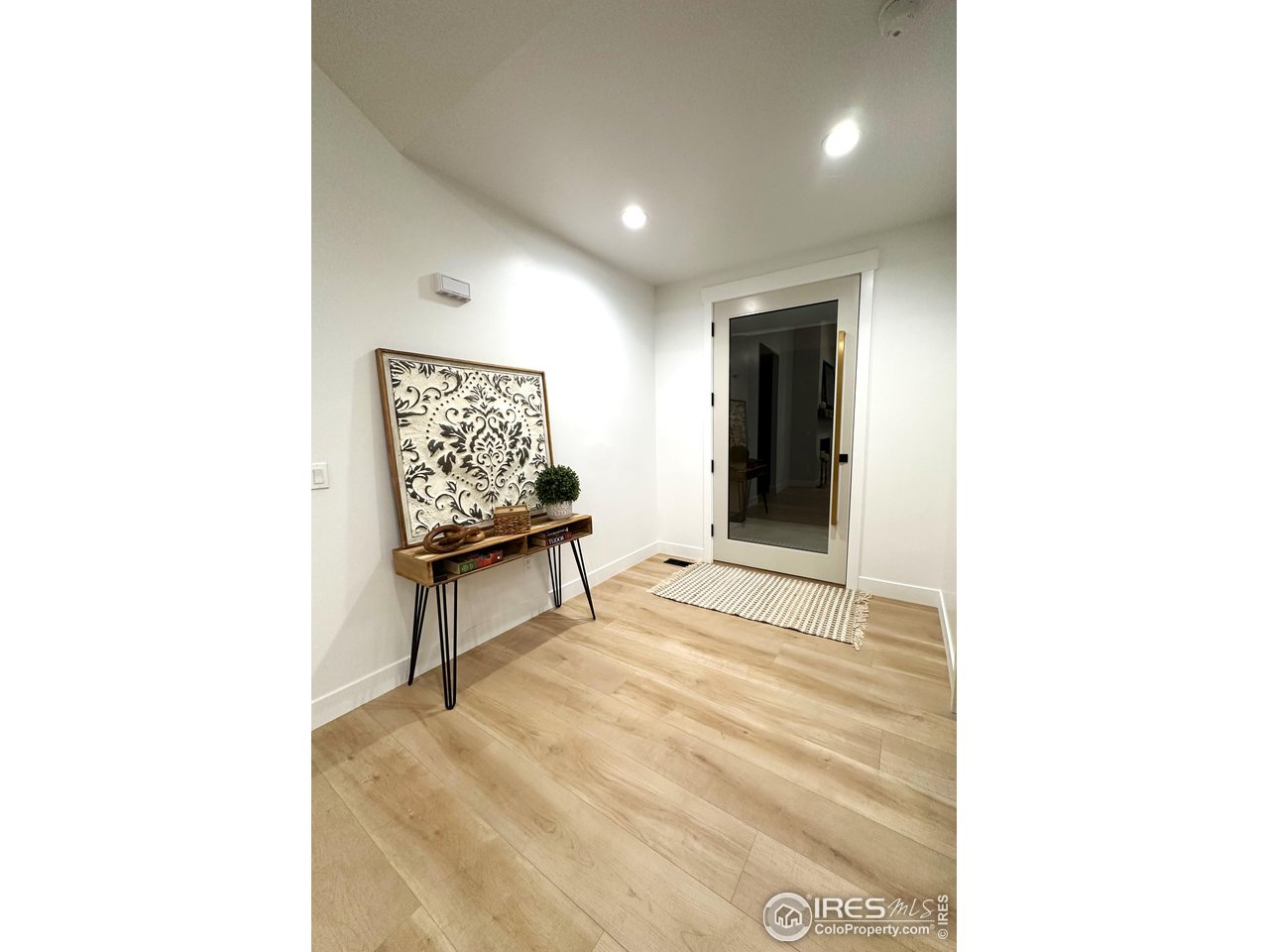 15276 Ypsilon Circle Mead, CO 80542 - Photo 6 of 40 a view of a hallway with wooden floor