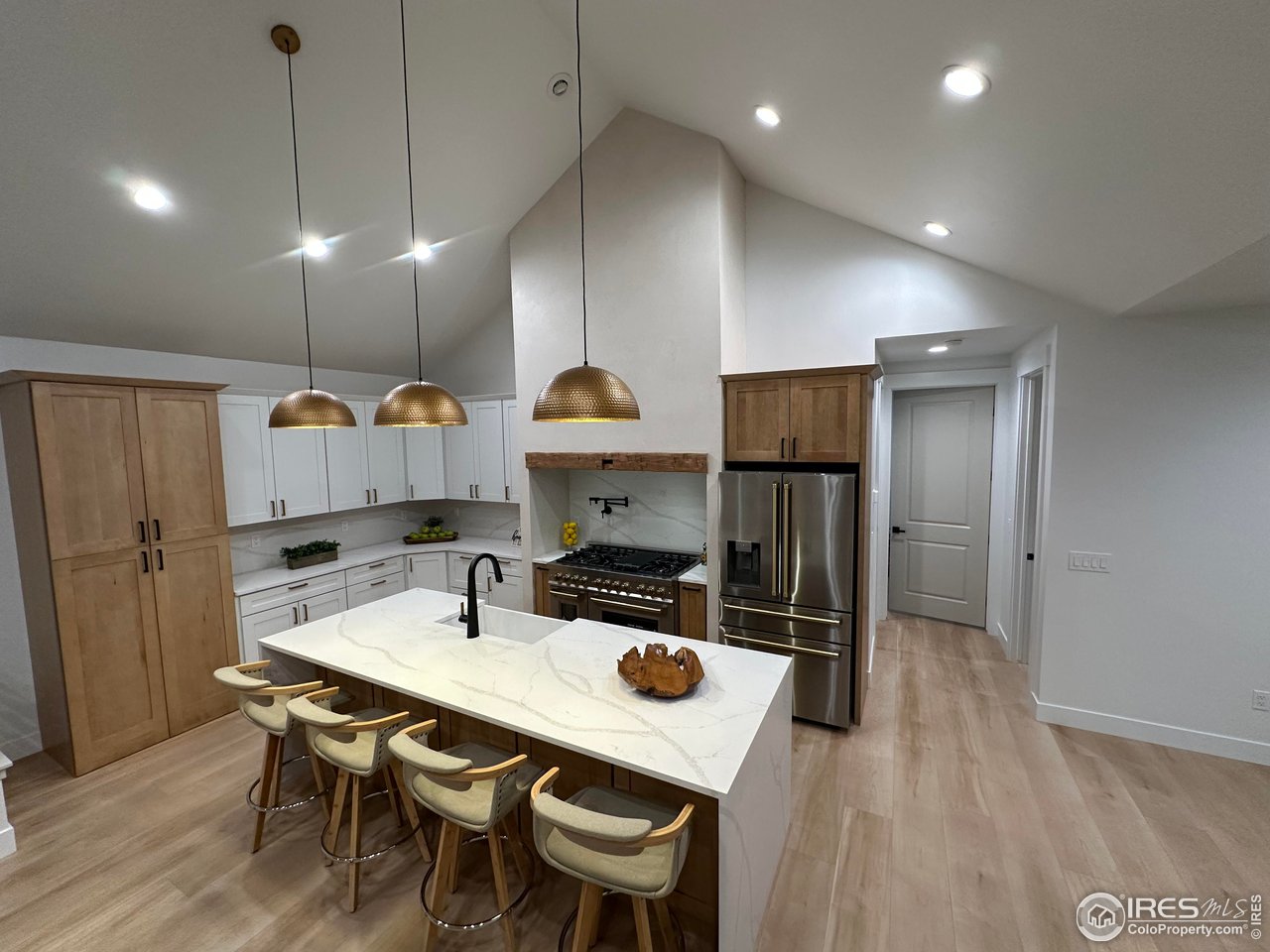 15276 Ypsilon Circle Mead, CO 80542 - Photo 8 of 40 a kitchen with a table chairs refrigerator and microwave