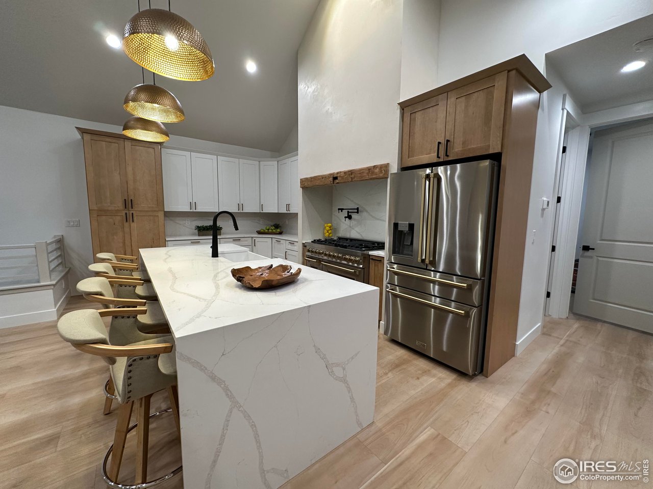 15276 Ypsilon Circle Mead, CO 80542 - Photo 9 of 40 a kitchen with refrigerator and table