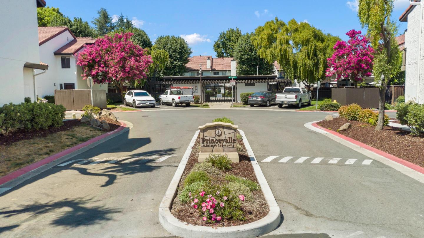 a swimming pool with outdoor seating and flowers