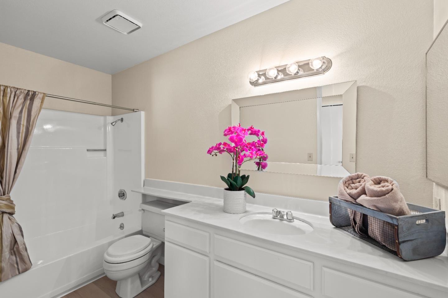 754 Gettysburg Way Gilroy, CA 95020 - Photo 38 of 56 a bathroom with a sink mirror and toilet