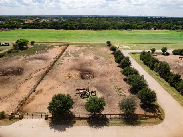 a view of a field with a building in the background