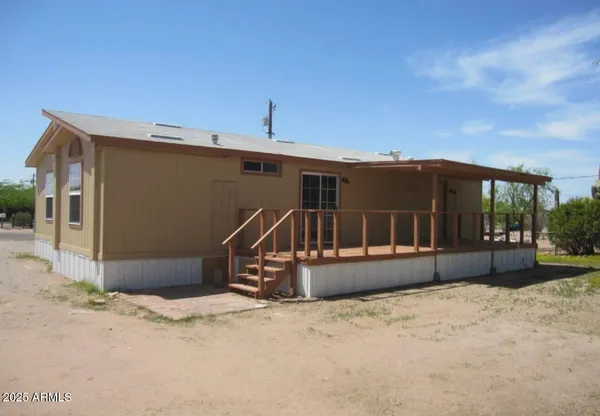 a view of a yard covered with snow in front of house