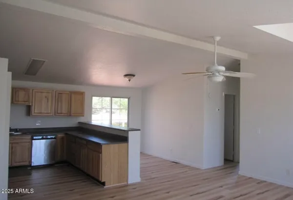 a kitchen with granite countertop a refrigerator and a stove top oven