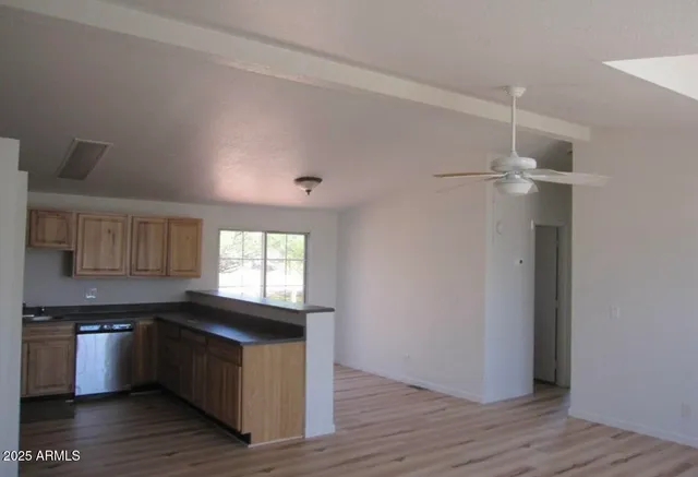 a kitchen with granite countertop a refrigerator and a stove top oven