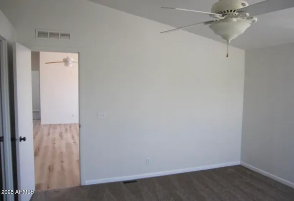 a view of a room with wooden floor