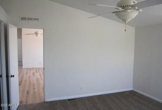 a view of a room with wooden floor