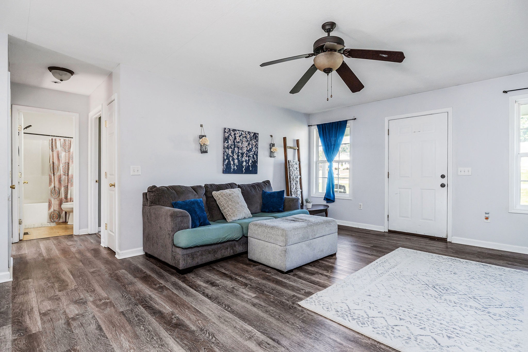 6215 Cheyenne Trail Baxter, TN 38544 - Photo 8 of 27 a living room with couches chandelier and kitchen view