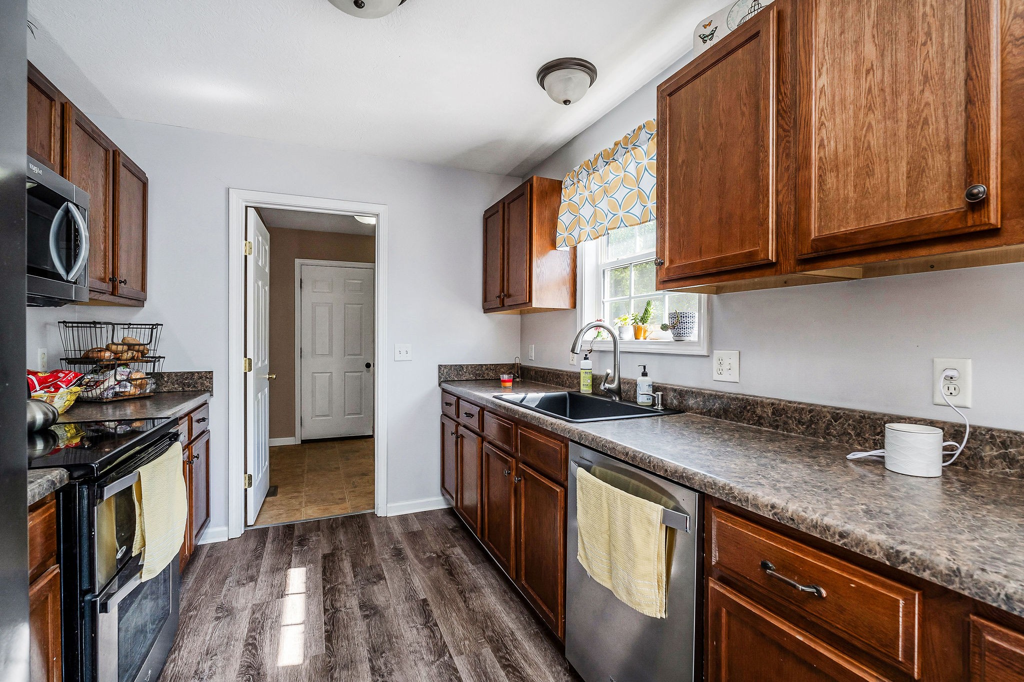 6215 Cheyenne Trail Baxter, TN 38544 - Photo 10 of 27 a kitchen with stainless steel appliances granite countertop a stove a sink dishwasher and cabinets with wooden floor