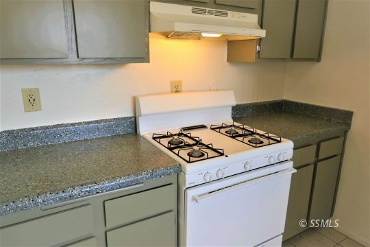 204 Sahara Drive Ridgecrest, CA 93555 - Photo 12 of 24 a stove top oven sitting inside of a kitchen