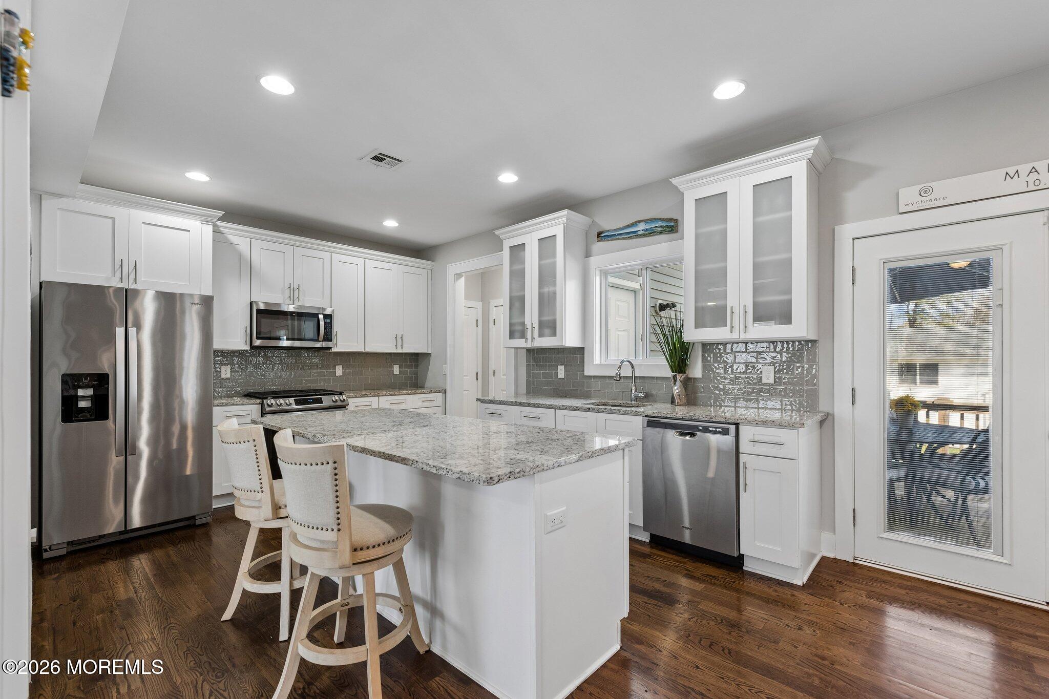 149 Berkeley Drive Brick, NJ 08724 - Photo 11 of 35 a kitchen with stainless steel appliances granite countertop a refrigerator a stove a sink a dining table and chairs