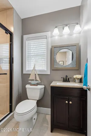 a bathroom with a toilet a sink and mirror
