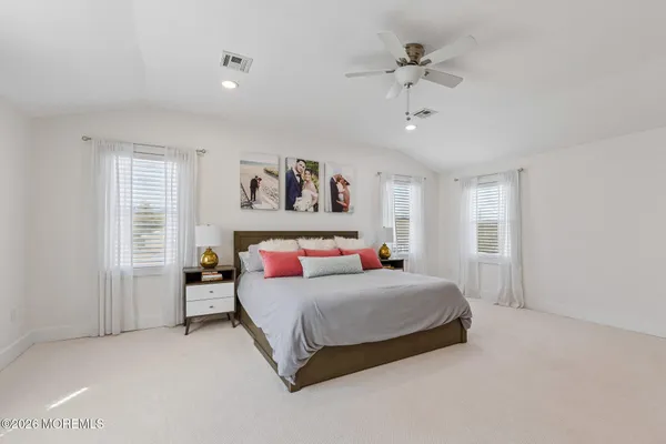 a bedroom with a bed and a ceiling fan
