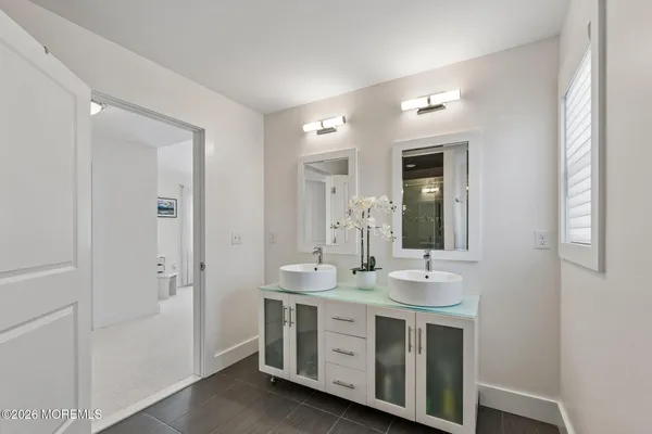 a bathroom with a double vanity sink and a mirror