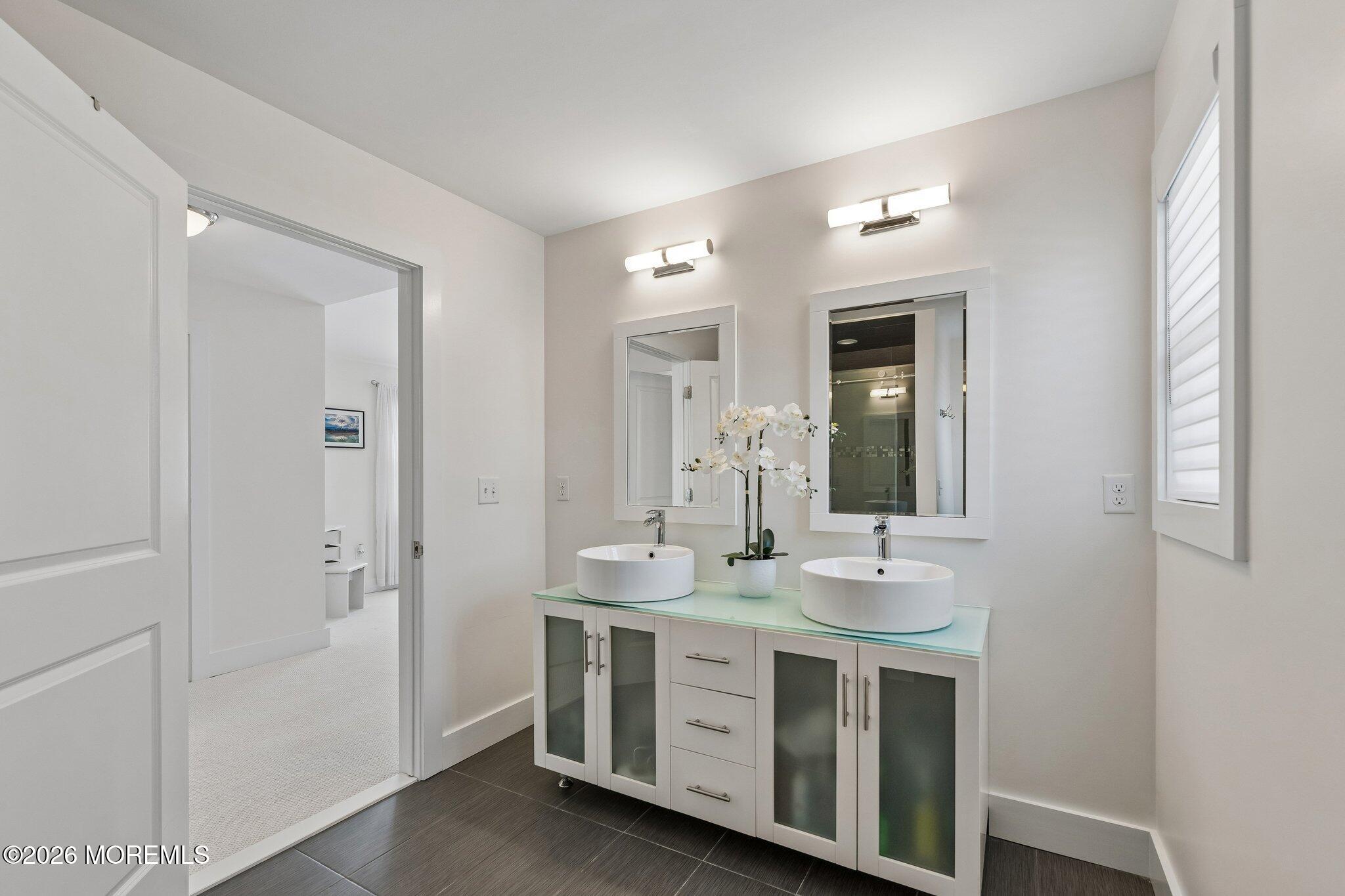 149 Berkeley Drive Brick, NJ 08724 - Photo 18 of 35 a bathroom with a double vanity sink and a mirror