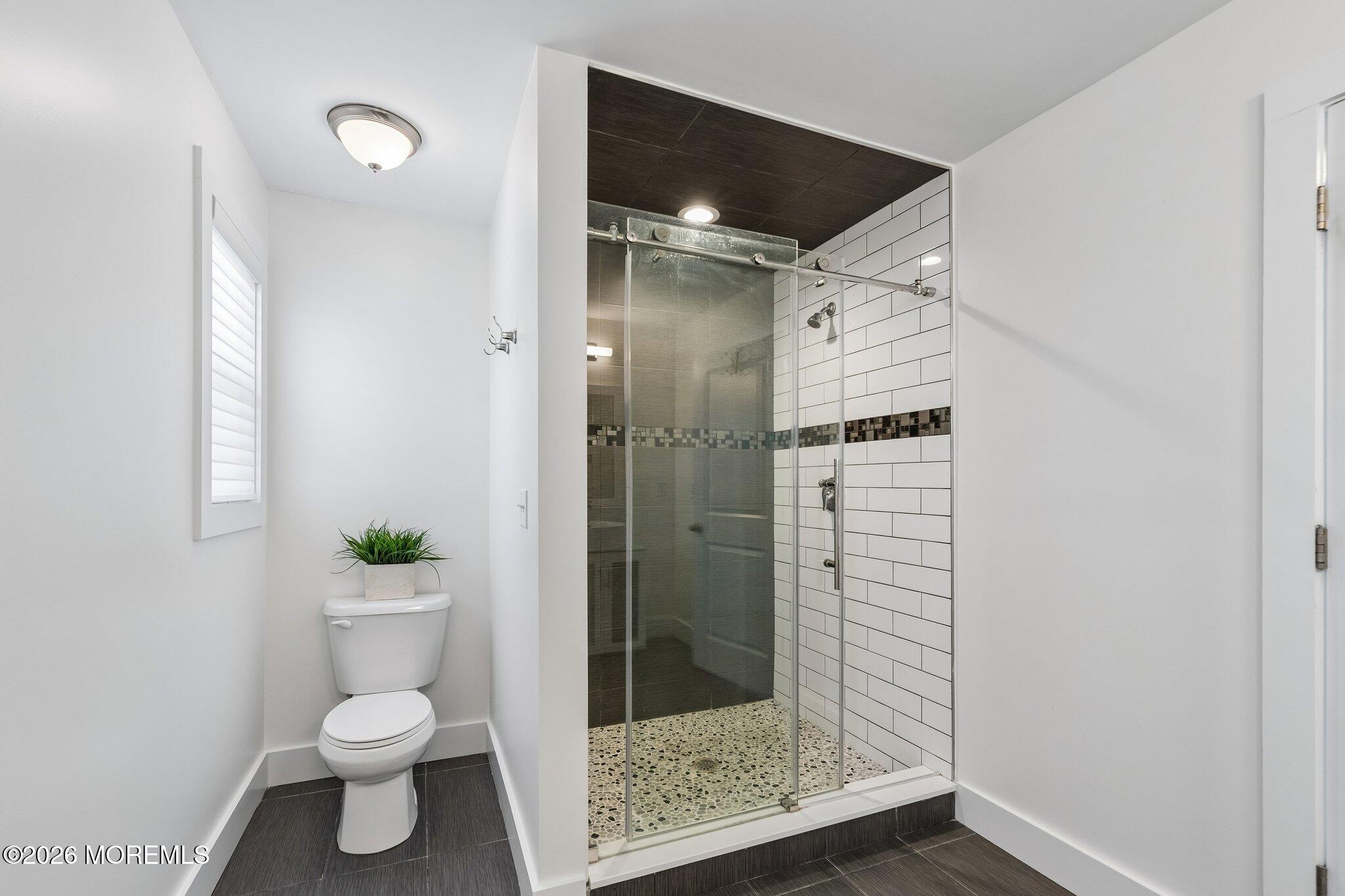 149 Berkeley Drive Brick, NJ 08724 - Photo 19 of 35 a bathroom with a shower and a toilet