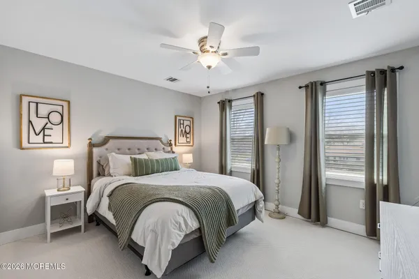 a bedroom with a large bed and a chandelier