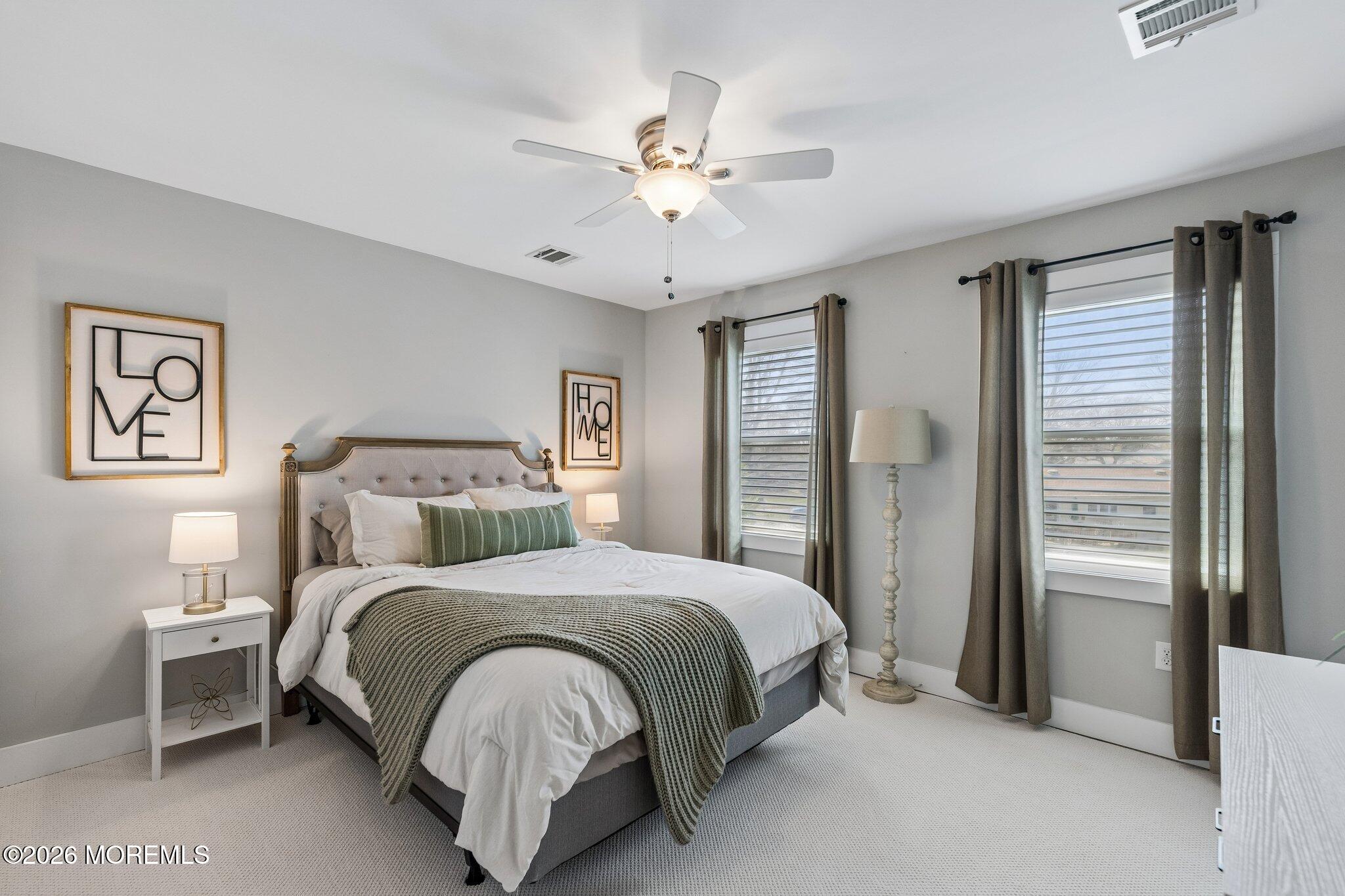 149 Berkeley Drive Brick, NJ 08724 - Photo 20 of 35 a bedroom with a large bed and a chandelier