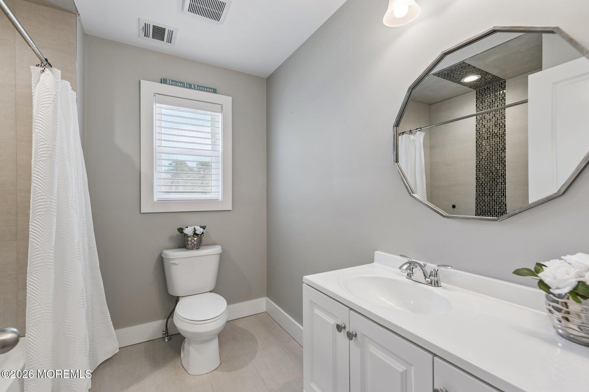 149 Berkeley Drive Brick, NJ 08724 - Photo 22 of 35 a bathroom with a toilet sink and mirror