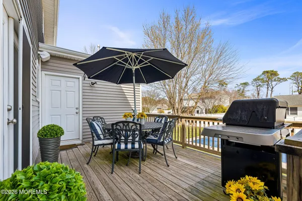 a view of a roof deck with table and chairs potted plants with wooden floor
