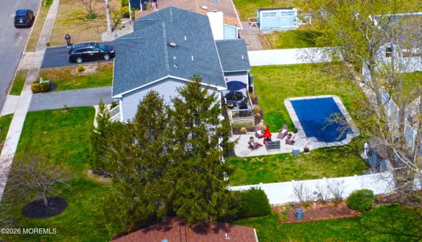 an aerial view of a house with a yard and garden