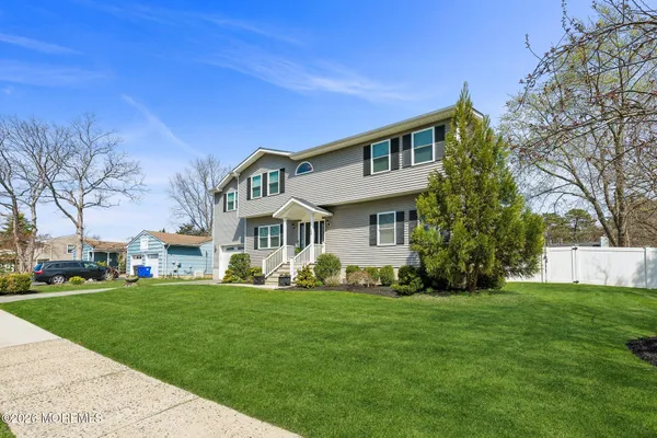 a front view of house with yard and green space