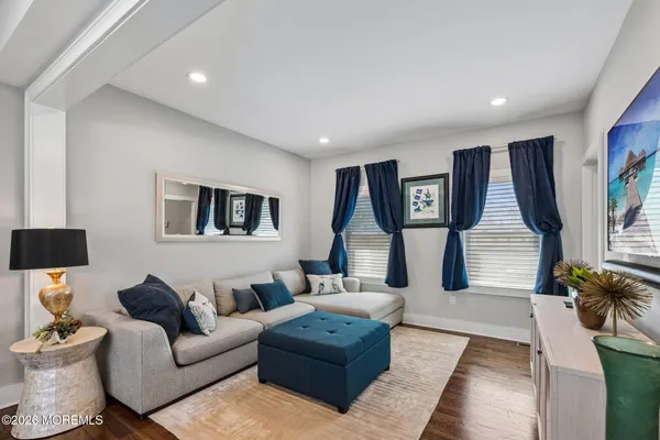 a living room with furniture and wooden floor