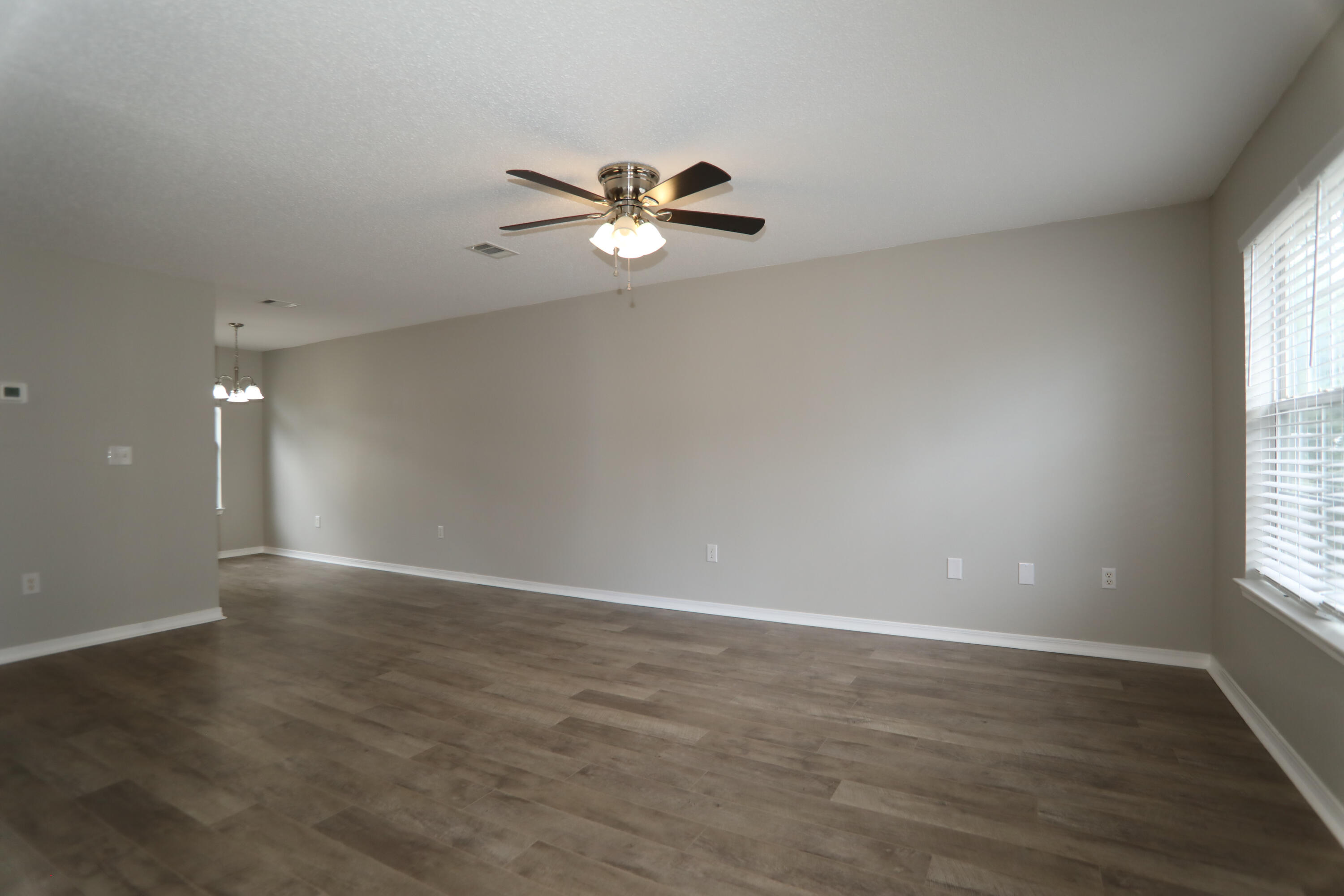 159 Patch Avenue Crestview, FL 32539 - Photo 3 of 11 wooden floor in an empty room with a window