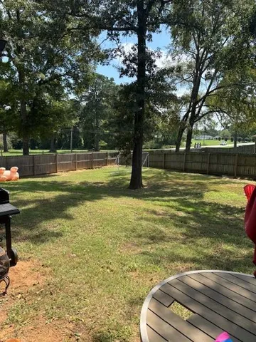 a view of a swimming pool with a yard