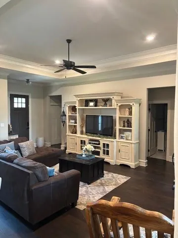 a living room with furniture and a flat screen tv