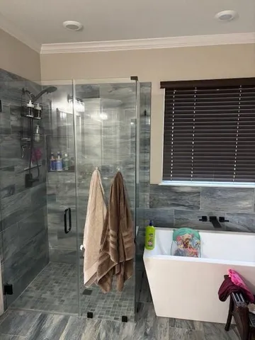 a view of a bathroom with a bathtub and shower