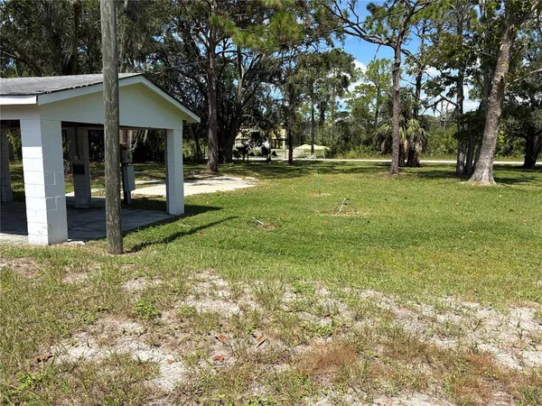 a view of a house with yard and balcony