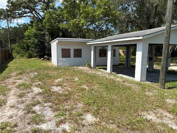 a view of a park with a tree in the background